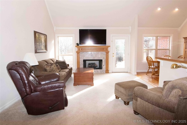 carpeted living room with crown molding and lofted ceiling