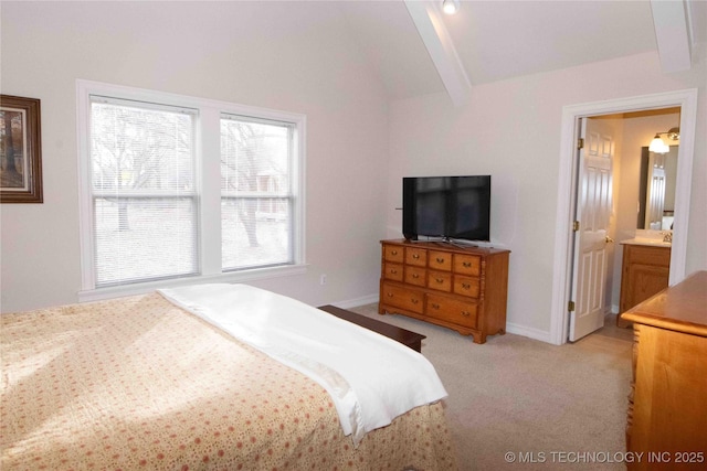 bedroom with vaulted ceiling with beams, ensuite bath, and light colored carpet