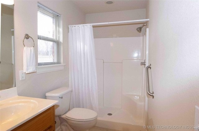 bathroom featuring vanity, toilet, and a shower with shower curtain