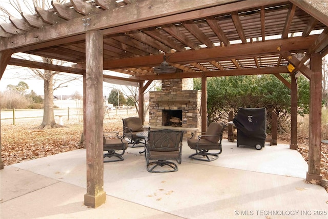 view of patio / terrace with an outdoor stone fireplace and a pergola