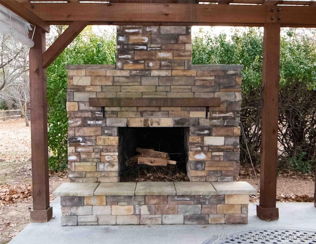 exterior details featuring an outdoor stone fireplace