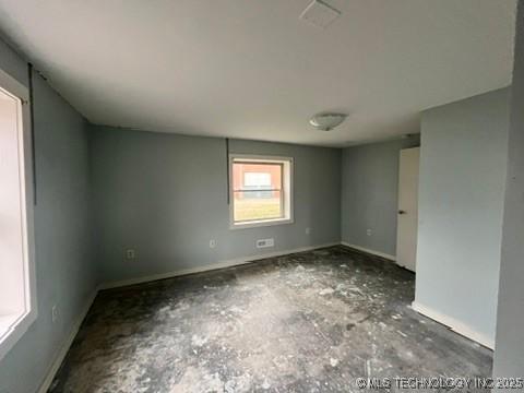 spare room with concrete flooring