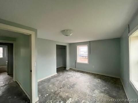 unfurnished bedroom featuring concrete flooring