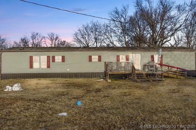 view of front of home featuring a yard and a wooden deck