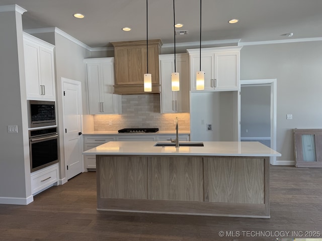 kitchen with crown molding, stainless steel appliances, a sink, and light countertops