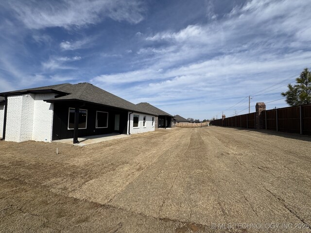 back of house featuring fence