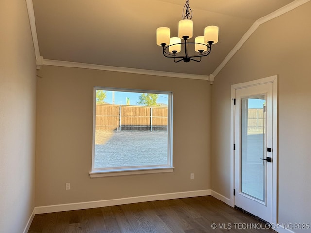 empty room featuring crown molding, a notable chandelier, dark wood finished floors, baseboards, and lofted ceiling