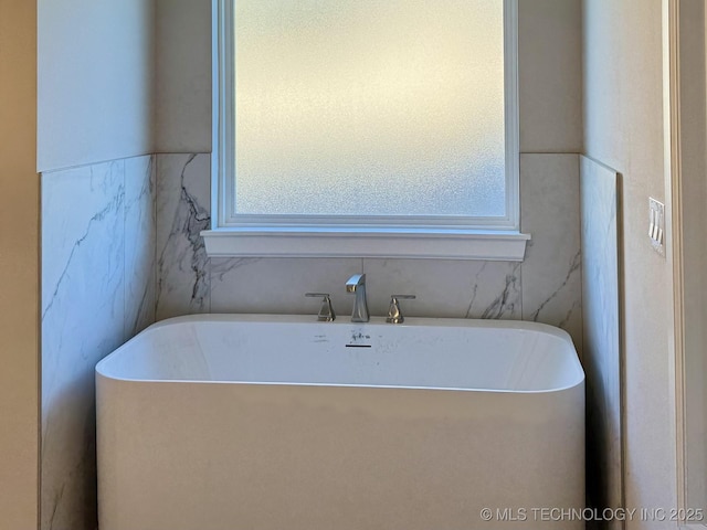 bathroom featuring a freestanding bath