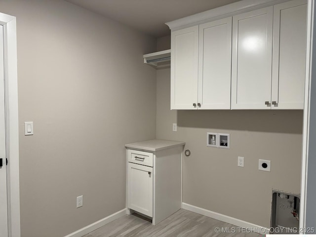 laundry room featuring hookup for a washing machine, cabinet space, light wood-style floors, electric dryer hookup, and baseboards