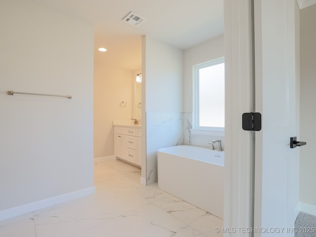 full bath with visible vents, a freestanding tub, baseboards, vanity, and marble finish floor