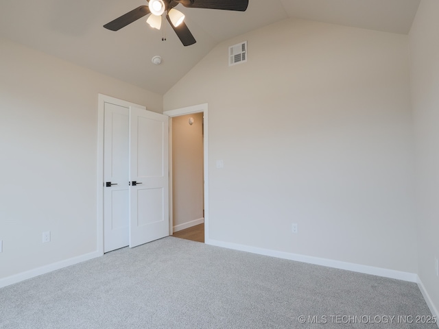 unfurnished bedroom with visible vents, baseboards, ceiling fan, carpet, and vaulted ceiling