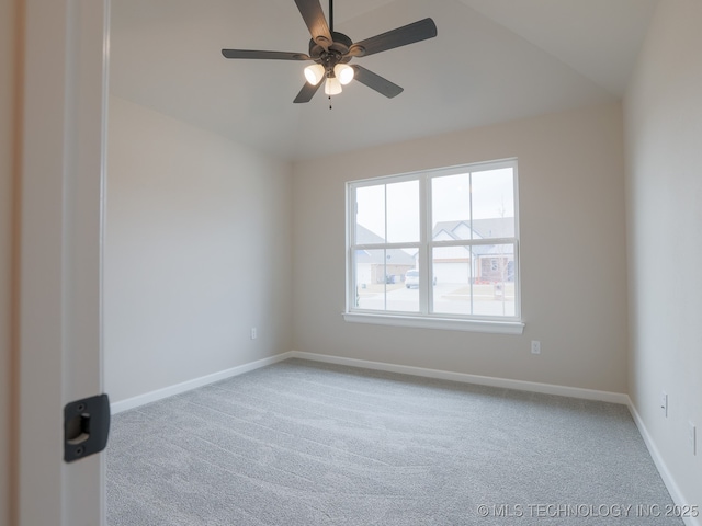 carpeted spare room featuring baseboards, ceiling fan, and lofted ceiling
