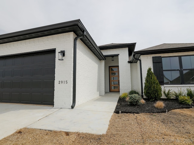 view of front of property with brick siding and an attached garage