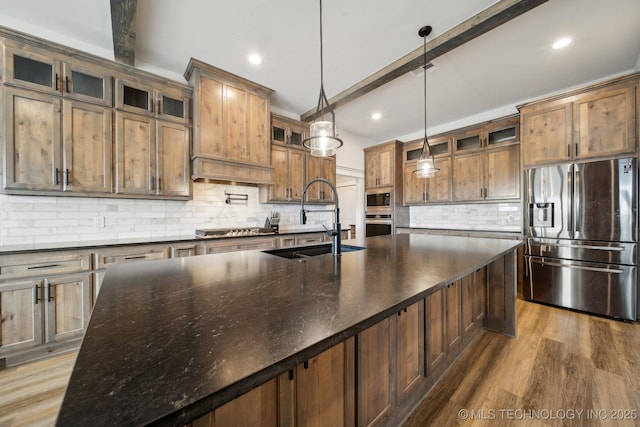 kitchen featuring pendant lighting, beam ceiling, decorative backsplash, sink, and appliances with stainless steel finishes