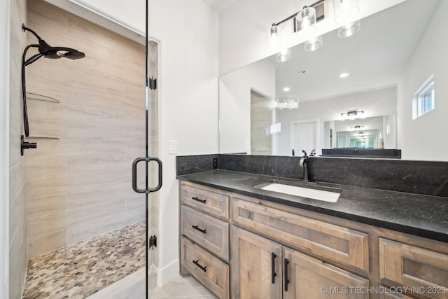 bathroom featuring vanity, tile patterned flooring, and a shower with door