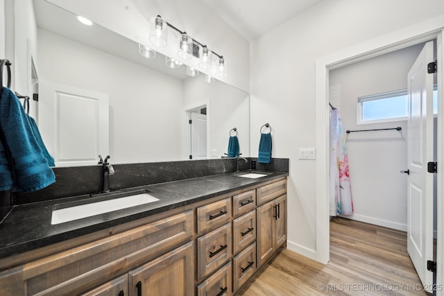 bathroom with hardwood / wood-style flooring and vanity