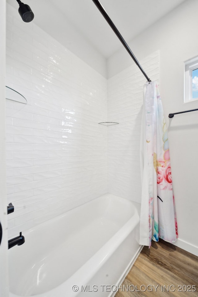 bathroom with shower / tub combo and wood-type flooring