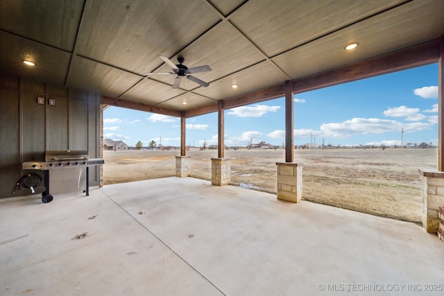 view of patio featuring grilling area, ceiling fan, and a rural view