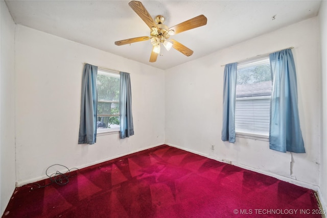 spare room with ceiling fan and a wealth of natural light