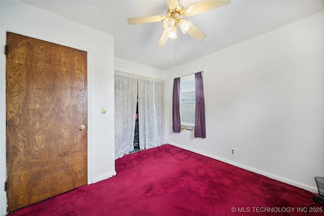 unfurnished bedroom with ceiling fan and carpet