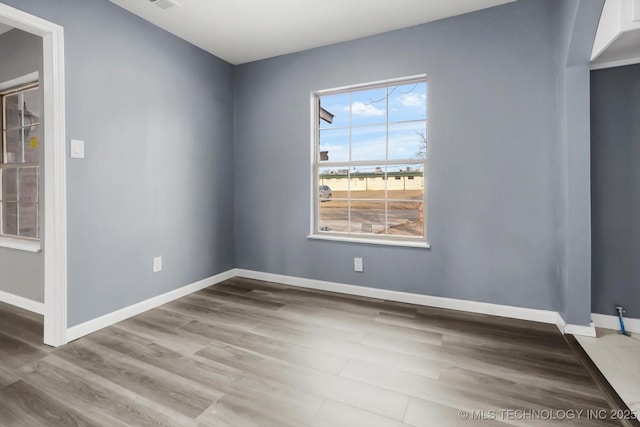 spare room with wood-type flooring