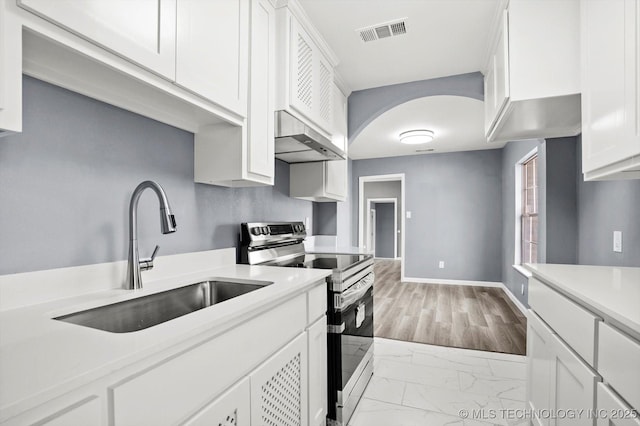 kitchen featuring ventilation hood, white cabinetry, sink, and stainless steel electric range