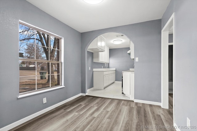 unfurnished dining area with light wood-type flooring