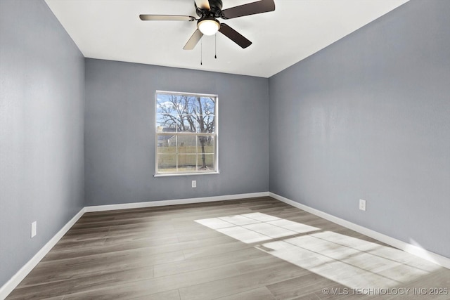 spare room with ceiling fan and light wood-type flooring