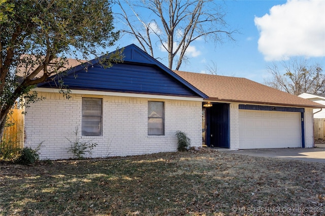 ranch-style home with a garage and a front yard