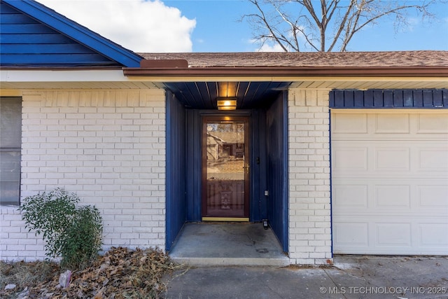 doorway to property with a garage