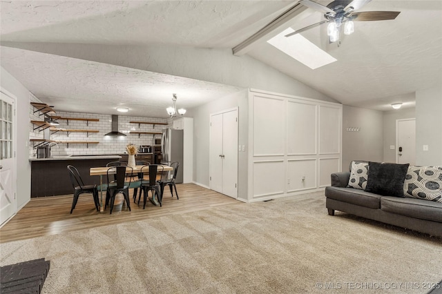 living room with light colored carpet, brick wall, lofted ceiling with beams, and a textured ceiling