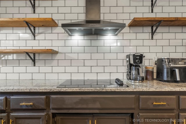 kitchen featuring black electric cooktop, light stone countertops, ventilation hood, and decorative backsplash