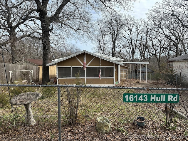 view of front of home featuring a sunroom