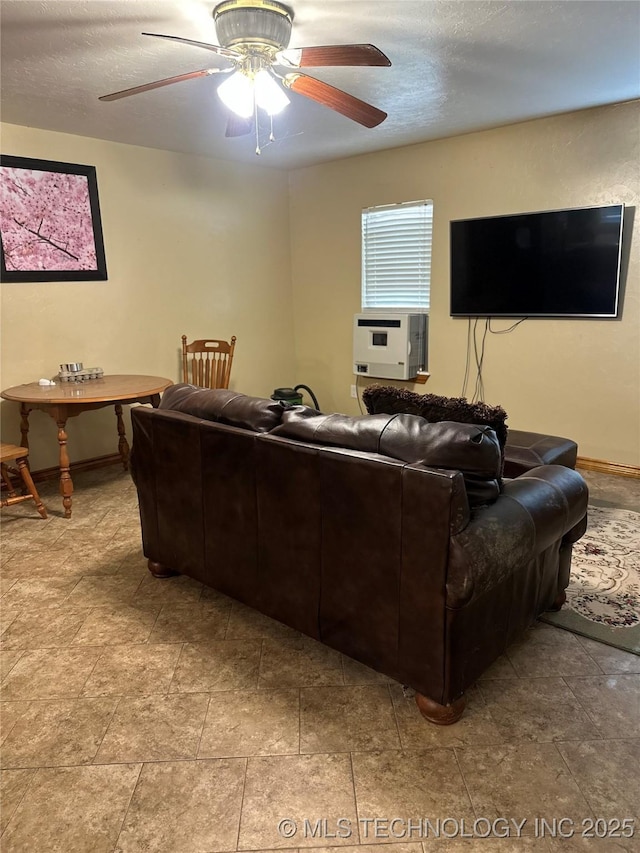 living room with ceiling fan, a textured ceiling, and cooling unit