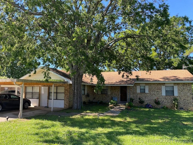 single story home with a front yard and a carport