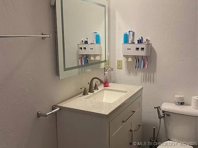 bathroom with toilet and vanity