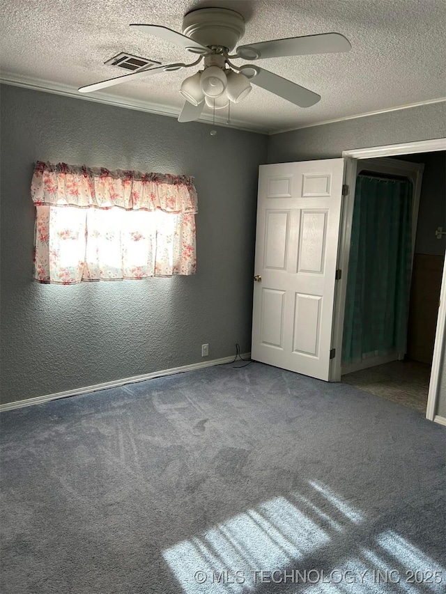 unfurnished bedroom featuring ceiling fan, carpet, and a textured ceiling