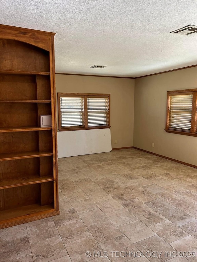 unfurnished room with a textured ceiling