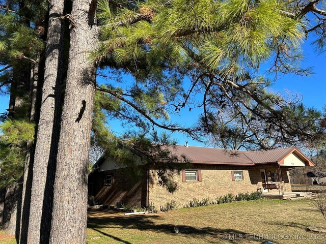 view of side of home featuring a lawn