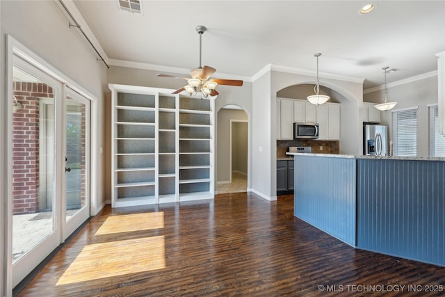 kitchen with decorative backsplash, plenty of natural light, stainless steel appliances, and light stone countertops