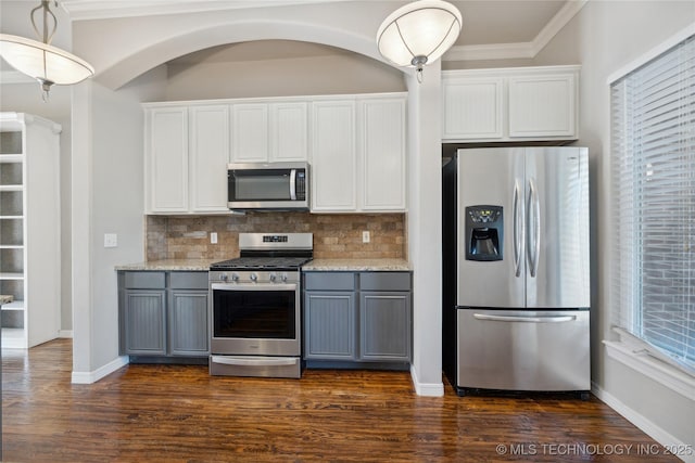 kitchen with white cabinets, decorative backsplash, gray cabinets, and stainless steel appliances