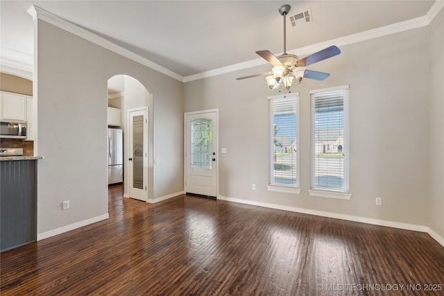 unfurnished living room featuring dark wood-type flooring, ornamental molding, and ceiling fan