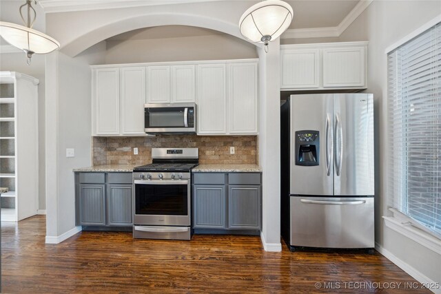 kitchen with backsplash, appliances with stainless steel finishes, gray cabinets, and white cabinetry