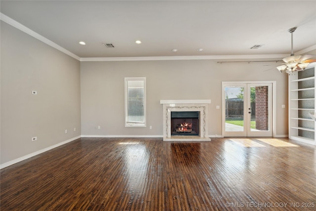 unfurnished living room with hardwood / wood-style floors, ceiling fan, ornamental molding, french doors, and a high end fireplace