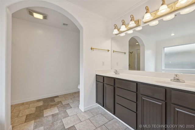 bathroom featuring toilet, vanity, and crown molding