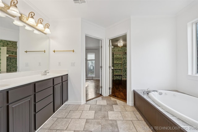 bathroom with vanity, a bathtub, tile patterned floors, and ornamental molding