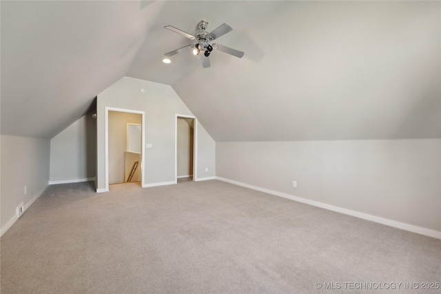 additional living space with vaulted ceiling, ceiling fan, and light carpet