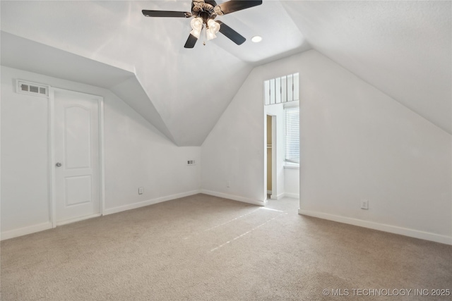 additional living space with vaulted ceiling, ceiling fan, and light colored carpet