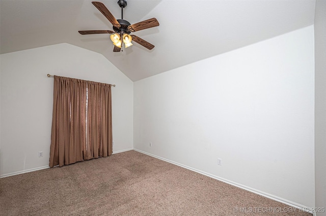 empty room featuring ceiling fan, carpet, and vaulted ceiling