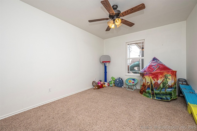 playroom featuring ceiling fan and carpet